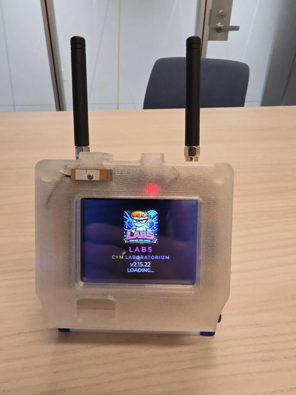CYM hardware in its translucent enclosure with screen and two antennas